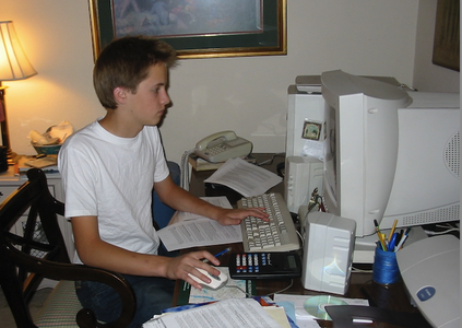 boy sitting at desk with computer